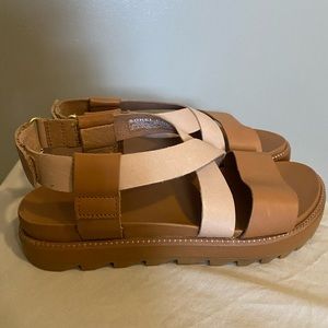 Sorel Roaming “criss cross” sandals in Camel Brown.